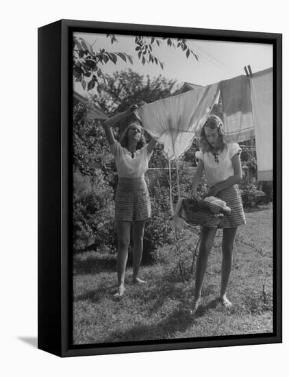 Teenage Twin Girls Hanging Laundry on Clothesline-Nina Leen-Framed Stretched Canvas