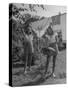 Teenage Twin Girls Hanging Laundry on Clothesline-Nina Leen-Stretched Canvas