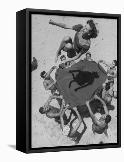 Teenaged Boys Using Blanket to Toss Their Friend, Norma Baker, Into the Air on the Beach-John Florea-Framed Stretched Canvas