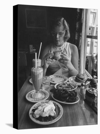 Teenaged Girl Sitting in Drugstore Eating a Hamburger-Hank Walker-Stretched Canvas