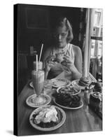 Teenaged Girl Sitting in Drugstore Eating a Hamburger-Hank Walker-Stretched Canvas