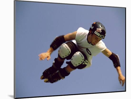 Teenager Inline Skating in Mid-Air-null-Mounted Photographic Print