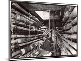 Telephone Repair Man Splicing a Wire in a Manhole for Telephone Cables of the New York Telephone Co-Margaret Bourke-White-Mounted Photographic Print