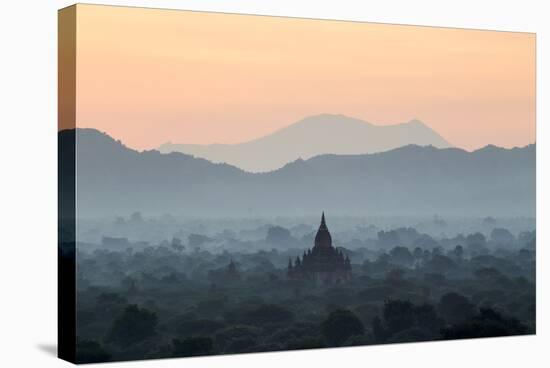 Temple in Early Morning Mist at Dawn, Bagan (Pagan), Myanmar (Burma)-Stephen Studd-Stretched Canvas