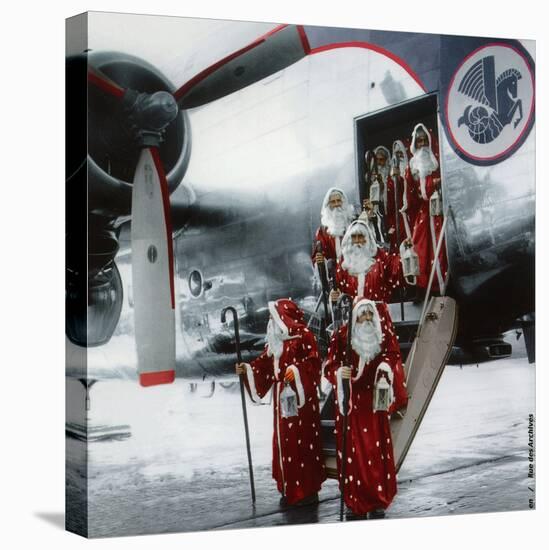 Ten Santa Claus Deplaning December 15, 1953. Colorized Document-null-Stretched Canvas