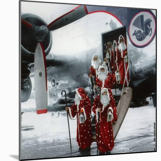 Ten Santa Claus Deplaning December 15, 1953. Colorized Document-null-Mounted Photo