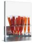 Test tubes filled with orange liquid-Kristopher Grunert-Stretched Canvas