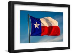 TEXAS STATE FLAG - Texas "Lone Star" flag stands out against a cloudless blue sky as it flys in...-null-Framed Photographic Print