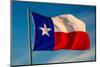 TEXAS STATE FLAG - Texas "Lone Star" flag stands out against a cloudless blue sky as it flys in...-null-Mounted Photographic Print