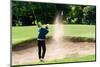 Thai Young Man Golf Player in Action Swing in Sand Pit during Practice before Golf Tournament at Go-Kitzero-Mounted Photographic Print