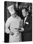 The 21 Club's Jack Kriendler Wearing a Tuxedo and Conferring with a Chef in the Club's Kitchen-null-Stretched Canvas
