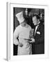 The 21 Club's Jack Kriendler Wearing a Tuxedo and Conferring with a Chef in the Club's Kitchen-null-Framed Photographic Print