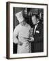 The 21 Club's Jack Kriendler Wearing a Tuxedo and Conferring with a Chef in the Club's Kitchen-null-Framed Photographic Print