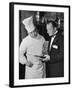 The 21 Club's Jack Kriendler Wearing a Tuxedo and Conferring with a Chef in the Club's Kitchen-null-Framed Photographic Print