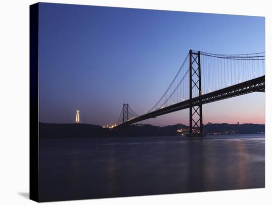 The 25 April Suspension Bridge at Dusk over the River Tagus (Rio Tejo), Christus Rei Is Illuminated-Stuart Forster-Stretched Canvas