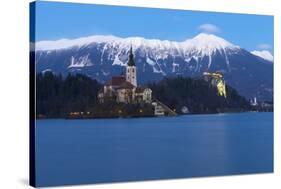The Assumption of Mary Pilgrimage Church on Lake Bled and Bled Castle at Dusk, Bled, Slovenia-Miles Ertman-Stretched Canvas