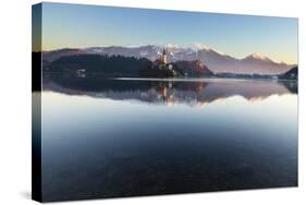 The Assumption of Mary Pilgrimage Church on Lake Bled and Bled Castle, Bled, Slovenia, Europe-Miles Ertman-Stretched Canvas