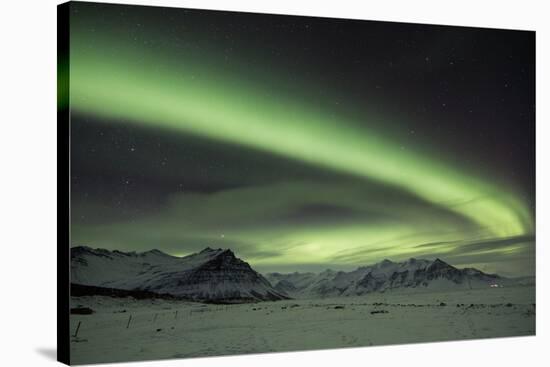 The Aurora Borealis in Iceland with Mountains in the Background-Alex Saberi-Stretched Canvas