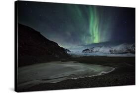 The Aurora Borealis over a Glacier in the Skaftafell National Park in Iceland-Alex Saberi-Stretched Canvas