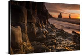 The basalt rock formations in the sea on Reynisfjara Beach in Vik, Iceland at sunrise.-Alex Saberi-Stretched Canvas