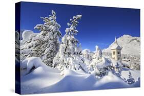 The bell tower submerged by snow surrounded by woods Maloja Canton of Engadine Switzerland Europe-ClickAlps-Stretched Canvas