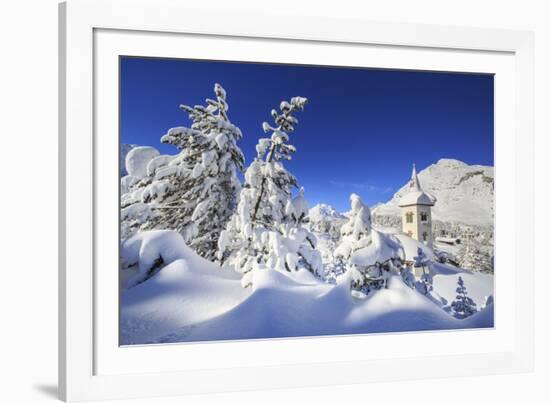 The bell tower submerged by snow surrounded by woods Maloja Canton of Engadine Switzerland Europe-ClickAlps-Framed Photographic Print