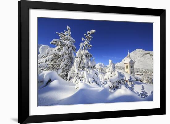 The bell tower submerged by snow surrounded by woods Maloja Canton of Engadine Switzerland Europe-ClickAlps-Framed Photographic Print