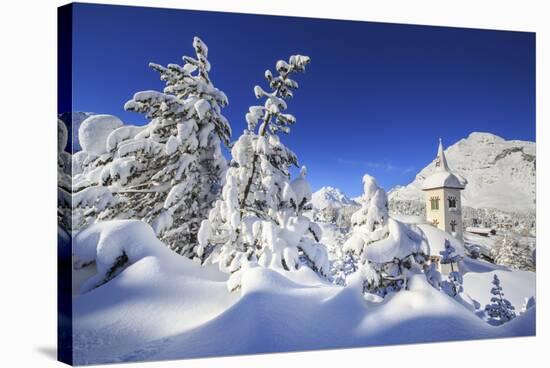 The bell tower submerged by snow surrounded by woods Maloja Canton of Engadine Switzerland Europe-ClickAlps-Stretched Canvas