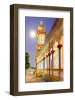 The Cao Dai temple in Vung Tau lit up at dusk with the full moon to the left of the tower, Vietnam-Brian Graney-Framed Photographic Print