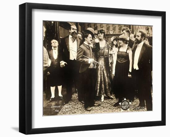 THE COUNT, foreground left: Charlie Chaplin, foreground second from right: Edna Purviance, 1916.-null-Framed Art Print