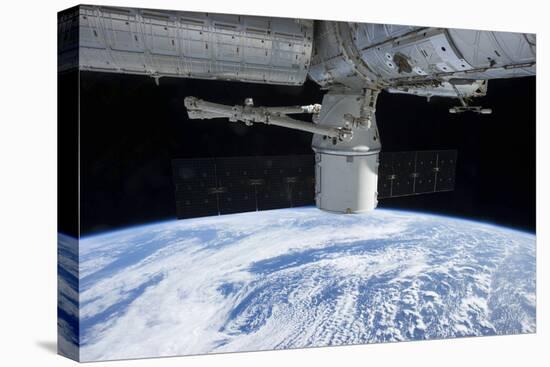 The Docking of Spacex Dragon to the International Space Station Above Earth-null-Stretched Canvas