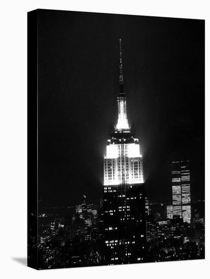 The Empire State Building Lights up at Night-null-Stretched Canvas