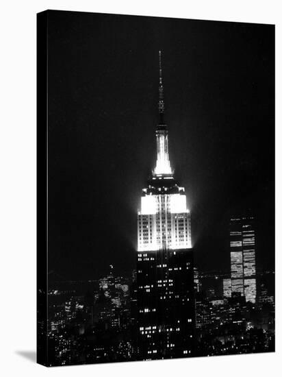 The Empire State Building Lights up at Night-null-Stretched Canvas