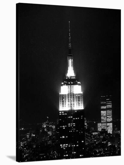 The Empire State Building Lights up at Night-null-Stretched Canvas