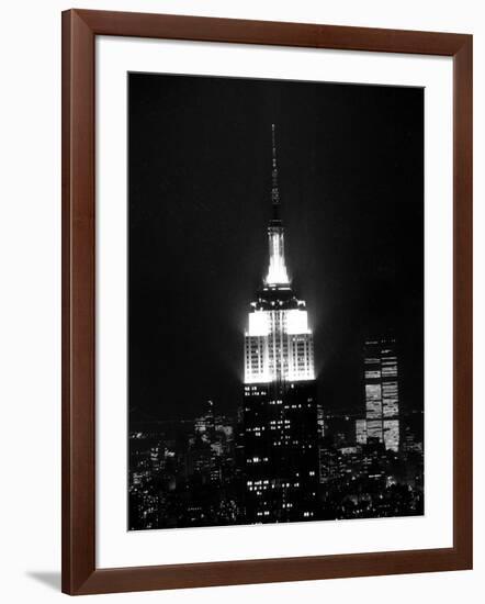 The Empire State Building Lights up at Night-null-Framed Photographic Print