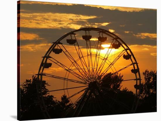 The Ferris Wheel at the Ingham County Fair is Silhouetted against the Setting Sun-null-Stretched Canvas