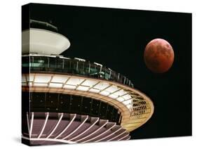 The Full Moon Turns Red and Orange as It Passes the Space Needle-null-Stretched Canvas