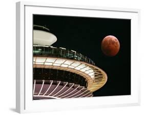 The Full Moon Turns Red and Orange as It Passes the Space Needle-null-Framed Photographic Print