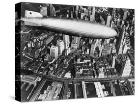 The German Airship, the Hindenburg, above Manhattan, New York in 1936, on its Way to its Berth at L-null-Stretched Canvas