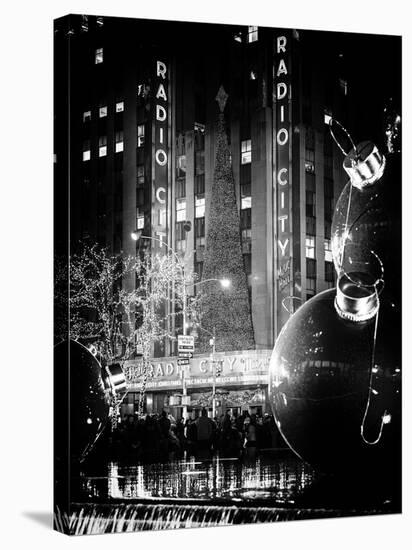 The Giant Christmas Ornaments on Sixth Avenue across from the Radio City Music Hall by Night-Philippe Hugonnard-Stretched Canvas