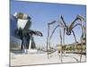 The Guggenheim, Designed by Architect Frank Gehry, and Giant Spider Sculpture by Louise Bourgeois-Christian Kober-Mounted Photographic Print