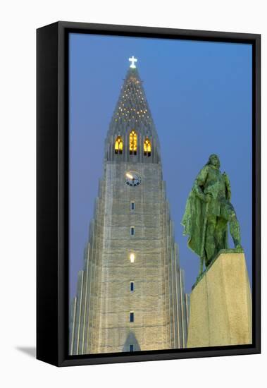 The Hallgrims Church with a statue of Leif Erikson in the foreground lit up at night, Reykjavik, Ic-Miles Ertman-Framed Stretched Canvas