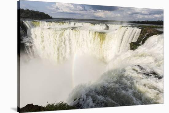The headwater of Iguazu Falls with a rainbow from the Argentinian-James White-Stretched Canvas