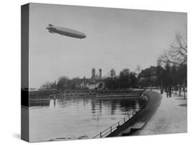 The Hindenburg Airship of Zeppelin Design Flying over City Where it was Fabricated-null-Stretched Canvas