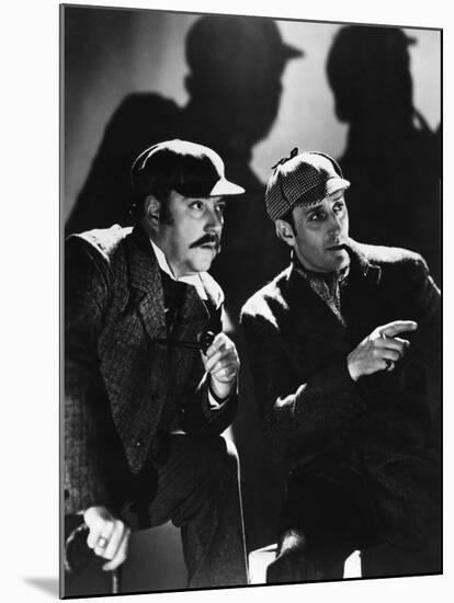 THE HOUND OF THE BASKERVILLES, 1939 directed by SIDNEY LANFIELD. Nigel Bruce and Basil Rathbone (b/-null-Mounted Photo