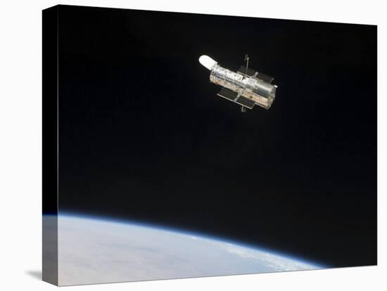 The Hubble Space Telescope in Orbit Above Earth-null-Stretched Canvas