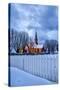 The illuminated church at dusk in the cold snowy landscape at Flakstad Lofoten Norway Europe-ClickAlps-Stretched Canvas