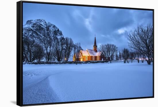 The illuminated church at dusk in the cold snowy landscape at Flakstad Lofoten Norway Europe-ClickAlps-Framed Stretched Canvas