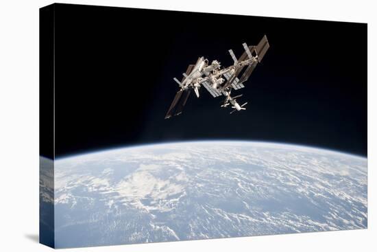 The International Space Station in Orbit Above Earth-null-Stretched Canvas