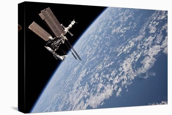 The International Space Station in Orbit Above Earth-null-Stretched Canvas